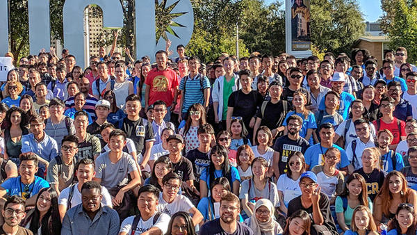 International students group in front of UCR sign