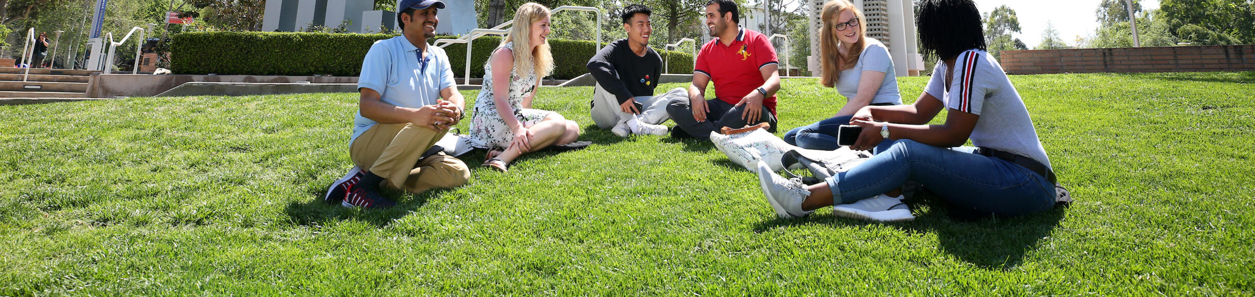 picture of students infront of UCR sign and bell tower