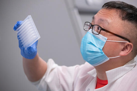 Assistant Professor Rong Hai prepares equipment in the COVID-19 testing lab (UCR/Stan Lim)